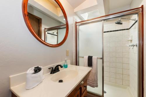 a bathroom with a sink and a shower with a mirror at Summit Happy Cabin with HOT TUB! HIGH SPEED EV HOOKUP, CLOSE TO SLOPES in Big Bear Lake