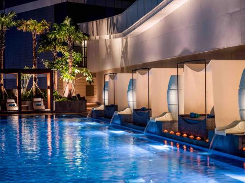 a swimming pool at a hotel with a resort at InterContinental Hotels Jakarta Pondok Indah by IHG in Jakarta