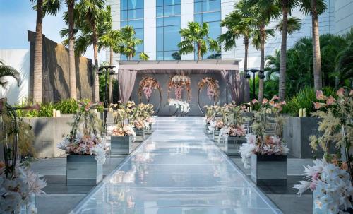 an aisle at a wedding with flowers and a canopy at InterContinental Hotels Jakarta Pondok Indah by IHG in Jakarta