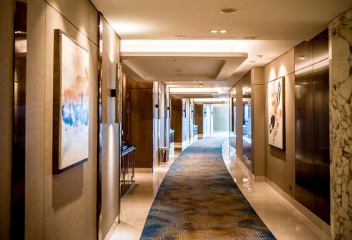 a hallway in a hotel with a rug on the floor at InterContinental Hotels Jakarta Pondok Indah by IHG in Jakarta