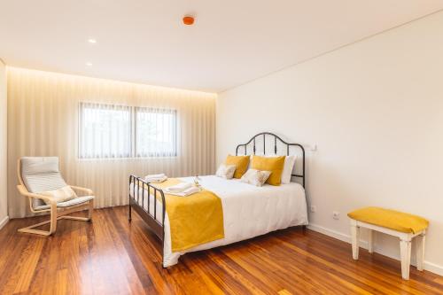 En eller flere senge i et værelse på Casa 141- familiar conforto paz e bem-estar
