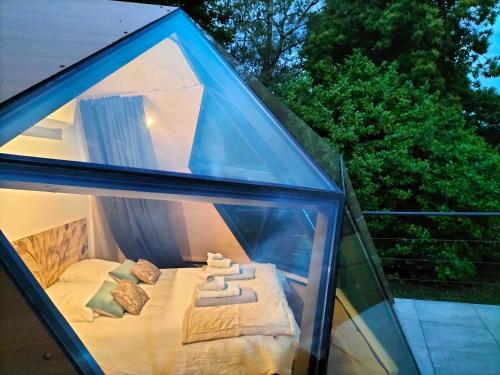 a glass house with a bed in it at Demeure de la Garenne in Montmirail