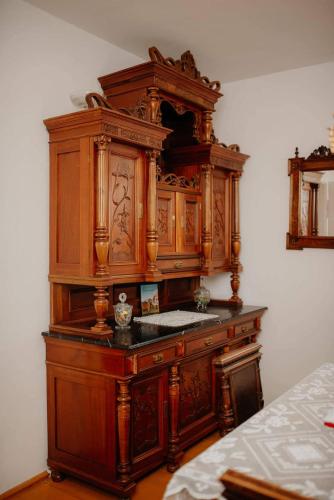 a large wooden cabinet in the corner of a room at Kuća za odmor "Šokačka lady" in Županja