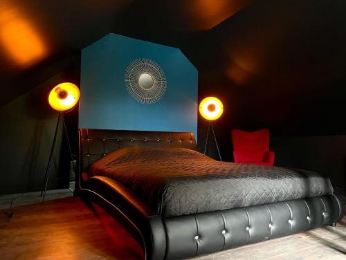a bedroom with a bed in a room with two lights at LoveRoom By Gîtes d'Armor in Plélo