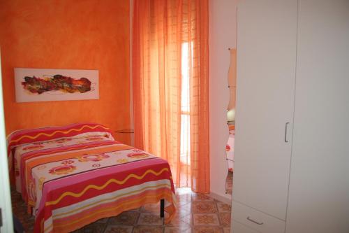 a small bedroom with a bed and a window at B&B Borgo Marinaro in Pozzuoli