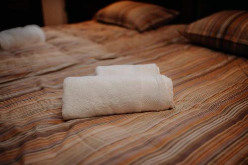 a white towel sitting on top of a bed at Kuća za odmor "Šokačka lady" in Županja