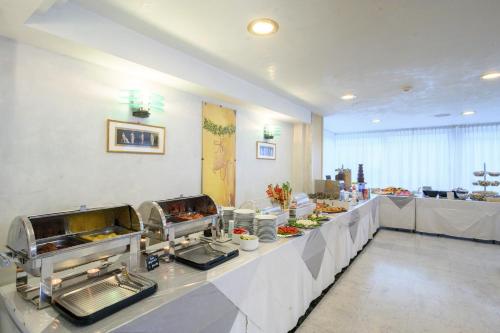 a buffet line with food on it in a restaurant at Atilius Hotel & Suites in Riccione