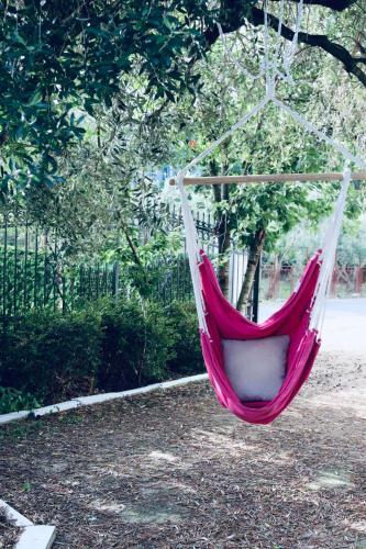 a red and white hammock hanging from a tree at Montebello Inn apartments in Ulcinj