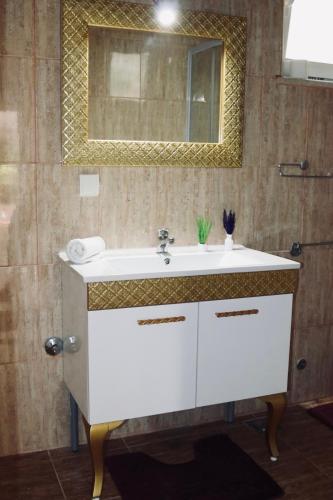a bathroom with a white sink and a mirror at Montebello Inn apartments in Ulcinj