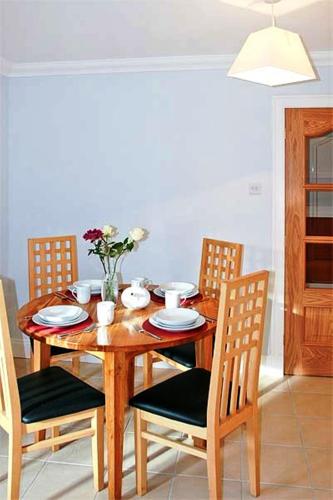 a wooden table with chairs and a dining room at Hillview House Hostel Inverness in Inverness