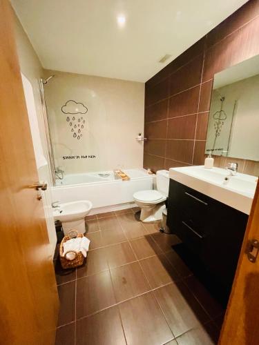 a bathroom with a tub and a toilet and a sink at Casa Río Duero in Soria