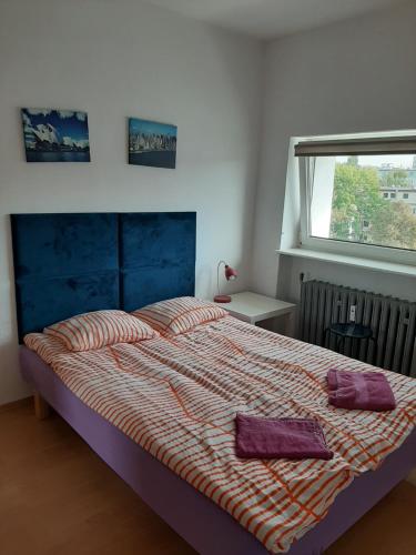 グディニャにあるApartament Śnieżka Centrumのベッドルーム1室(大型ベッド1台、紫色のタオル2枚付)