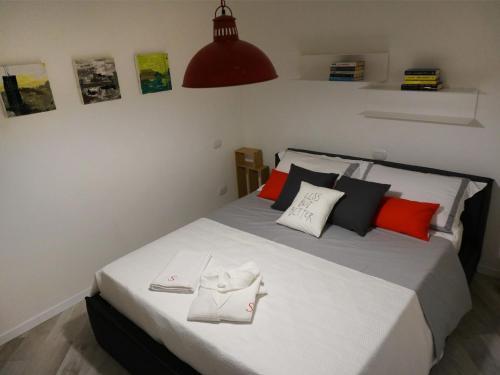 a bedroom with a bed with two towels on it at Les Suites di Parma in Parma