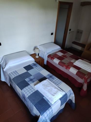 Postel nebo postele na pokoji v ubytování Agriturismo Le Cantine