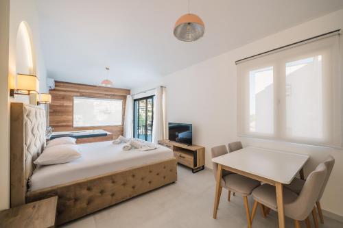 a bedroom with a bed and a table and a desk at Barba Apartments in Ulcinj