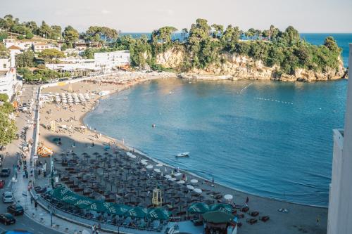 a view of a beach with umbrellas and the ocean at Barba Apartments in Ulcinj
