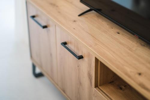 a wooden cabinet with a tv on top of it at Barba Apartments in Ulcinj