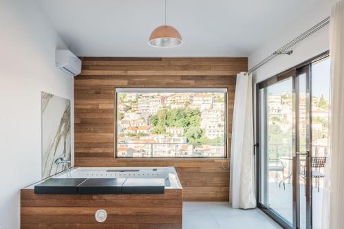 a kitchen with a sink and a large window at Barba Apartments in Ulcinj