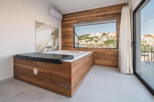 a bathroom with a bath tub with a large window at Barba Apartments in Ulcinj