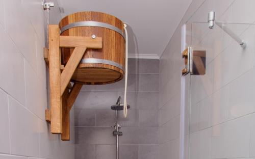 a shower with a wooden seat in a bathroom at Design Hotel Skopeli in Odesa