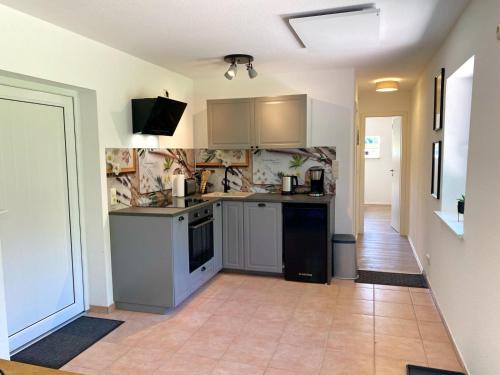 a kitchen with a sink and a stove at Hofgut Bisdamitz - Ferienhaus "Knoff" in Bisdamitz