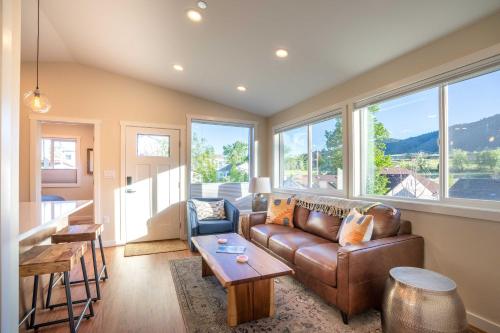 a living room with a couch and a table at Golden Cottage Near Red Rocks and School of Mines! in Golden
