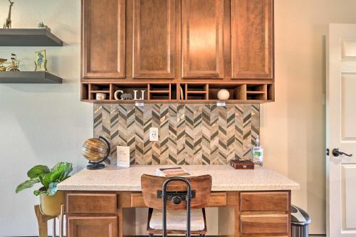 a kitchen with wooden cabinets and a counter top at Modern Desert Hot Springs Condo with Pool Access! in Desert Hot Springs