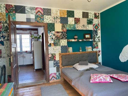 a bedroom with a bed and a wall covered in tiles at Apartament Do Zobaczenia Olsztyn in Olsztyn