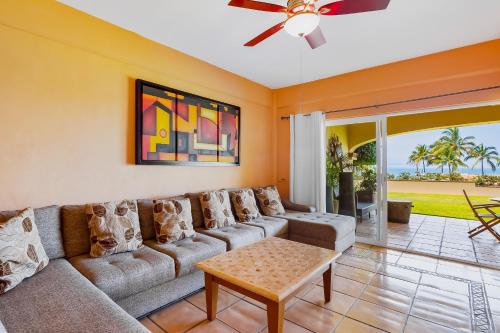 a living room with a couch and a ceiling fan at Anclote 5103 in Punta Mita