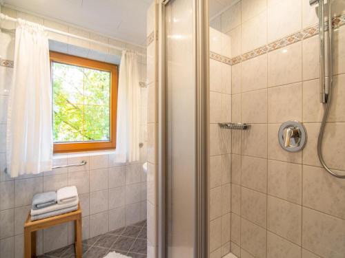 a bathroom with a shower with a glass door at Schleicherhof V in Strass im Zillertal