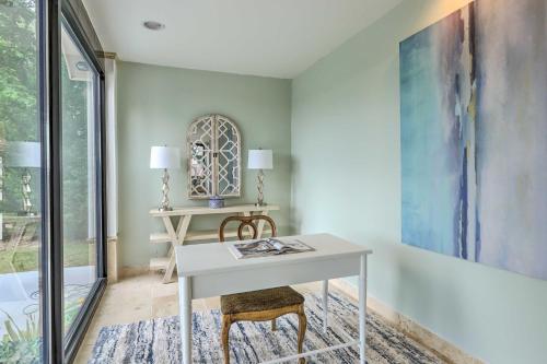 a room with a white desk and a table at Pickwick Lake Home with Screened-In Porch, Dock in Counce