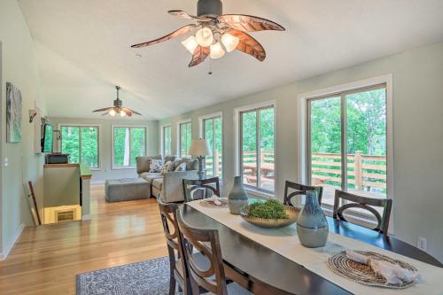 a dining room and living room with a ceiling fan at Pickwick Lake Home with Screened-In Porch, Dock in Counce