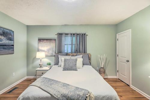 a bedroom with a large bed with green walls at Pickwick Lake Home with Screened-In Porch, Dock in Counce