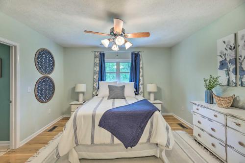a bedroom with a bed and a ceiling fan at Pickwick Lake Home with Screened-In Porch, Dock in Counce