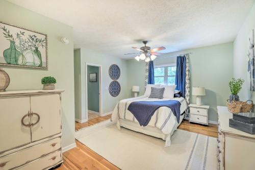 a bedroom with a bed and a ceiling fan at Pickwick Lake Home with Screened-In Porch, Dock in Counce