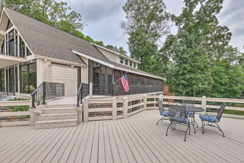 a house with a deck with a table and chairs at Pickwick Lake Home with Screened-In Porch, Dock in Counce