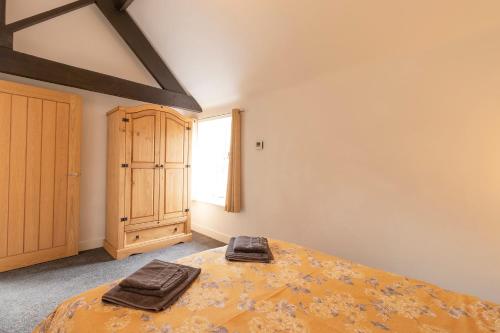 a bedroom with a bed with two bags on it at The Olde Coach House in Chesterfield