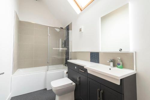 a bathroom with a sink and a toilet and a shower at The Olde Coach House in Chesterfield