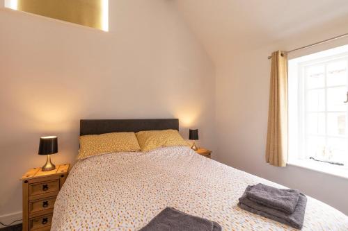 a bedroom with a bed and a window at The Olde Coach House in Chesterfield