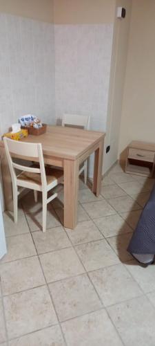 a wooden table and chair in a room at L'altra casa 1933 in Rionero in Vulture