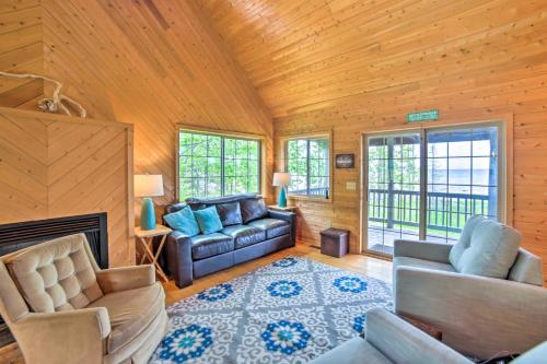 a living room with a couch and a fireplace at Secluded Lake Michigan Home Private Fire Pit in Manistique