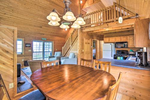 a dining room with a wooden table in a cabin at Secluded Lake Michigan Home Private Fire Pit in Manistique