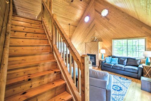 a staircase in a log cabin with a living room at Secluded Lake Michigan Home Private Fire Pit in Manistique
