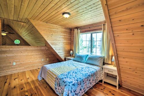 a bedroom with a bed and a wooden ceiling at Secluded Lake Michigan Home Private Fire Pit in Manistique