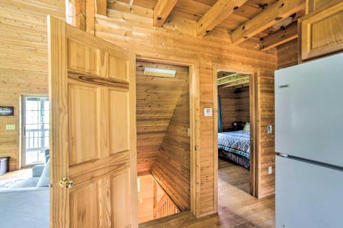 a wooden room with a refrigerator and a bedroom at Secluded Lake Michigan Home Private Fire Pit in Manistique