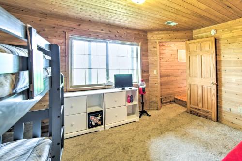 a bedroom with a bunk bed and a window at Secluded Lake Michigan Home Private Fire Pit in Manistique