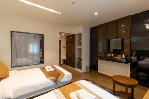 Un pat sau paturi într-o cameră la Nansc Hotel