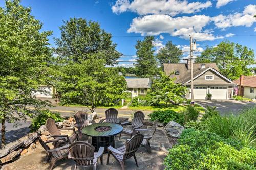 a patio with a table and chairs in a yard at Elegant Middlefield Getaway with Game Room! in Middlefield