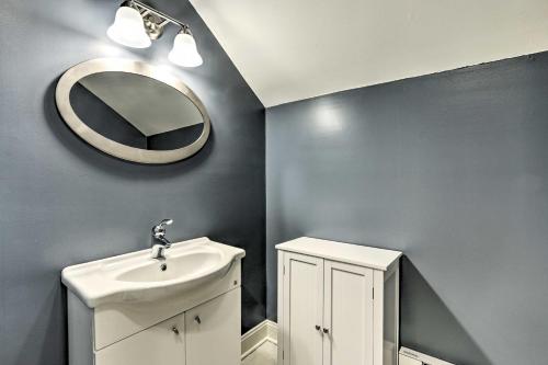 a bathroom with a sink and a mirror on the wall at Elegant Middlefield Getaway with Game Room! in Middlefield