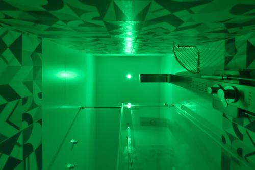 a green room with a shower and a toilet at Serenis Luxury Apartments in Minori
